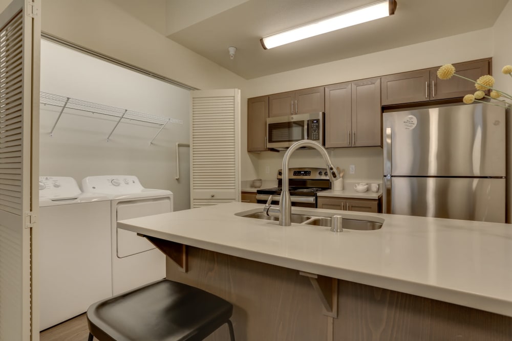 Kitchen with side by side washer/dryer at Haven Hills in Vancouver, Washington