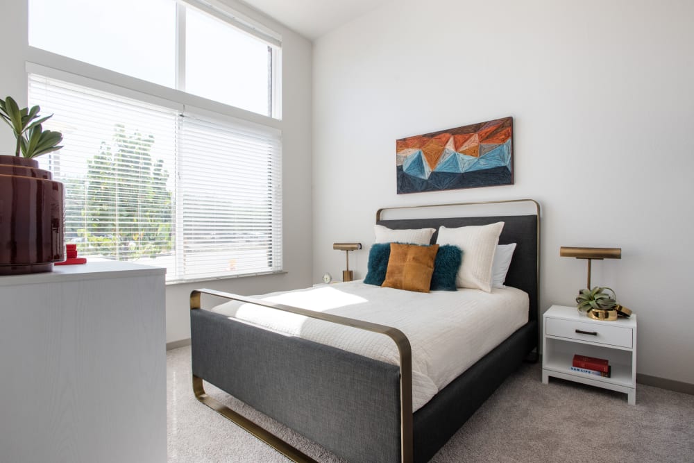 Bedroom with large windows at Marq Iliff Station in Aurora, Colorado