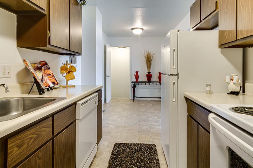 White appliances and oak cabinets in a kitchen at Briarcliffe Apartments & Townhomes in Lansing, Michigan