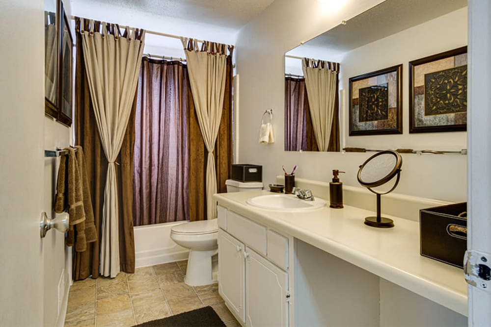 Well-lit bathroom in a home at Briarcliffe Apartments & Townhomes in Lansing, Michigan