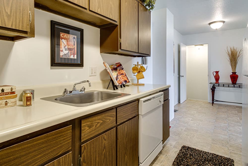 Oak cabinets and white appliances in a home at Briarcliffe Apartments & Townhomes in Lansing, Michigan