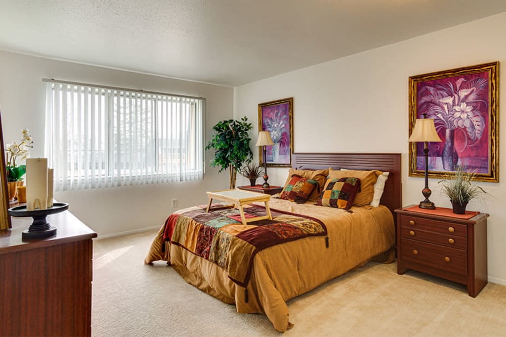 A spacious and furnished bedroom in a home at Briarcliffe Apartments & Townhomes in Lansing, Michigan
