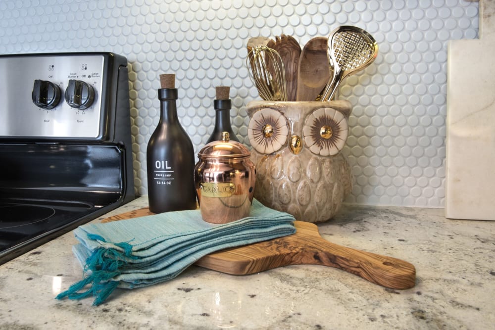 Kitchen counter in a decorated house with oil and a cutting board ready for cooking at Mercantile River District in Fort Worth, Texas