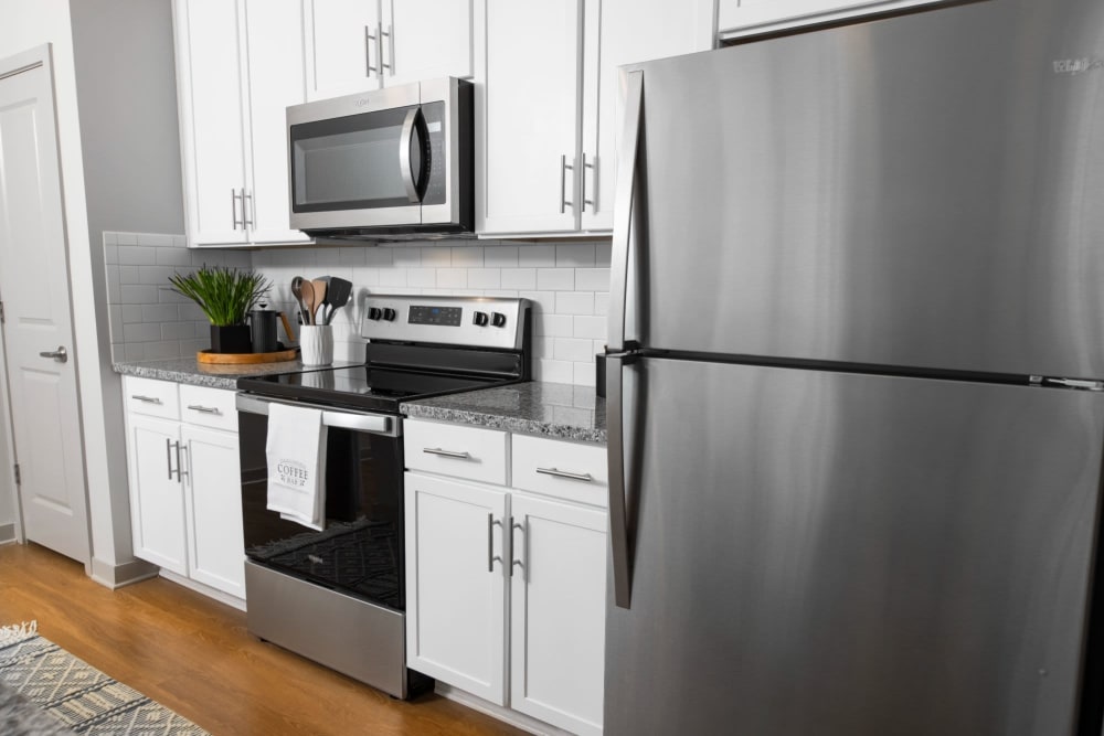 Stunning kitchen with white cabinets and stainless steel appliances at Parc at Murfreesboro in Murfreesboro, Tennessee