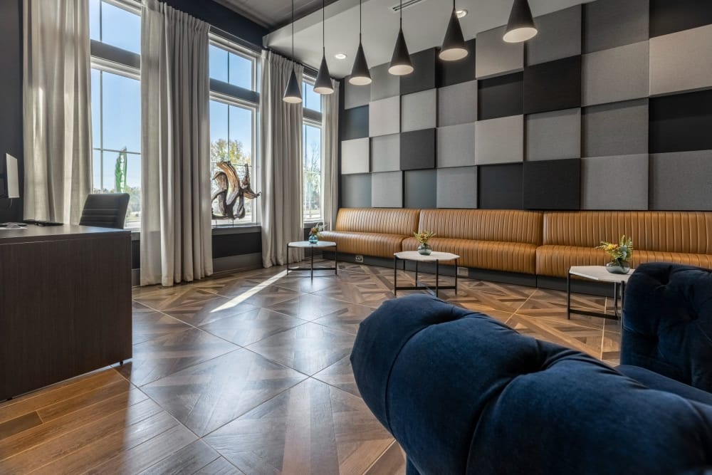 Lounge area near the front office with a large bench couch and tables to sit in at Parc at Murfreesboro in Murfreesboro, Tennessee