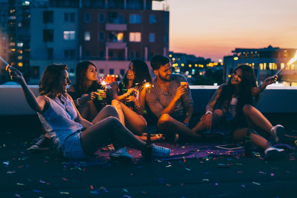 Residents relaxing on the rooftop lounge area at IDENTITY Logan Park in Berkeley, California