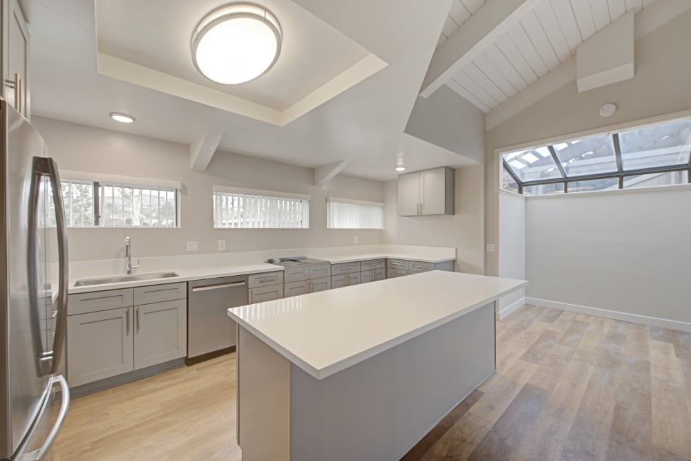 Modern kitchen with stainless steel appliances and a large island at Sofi Ventura in Ventura, California