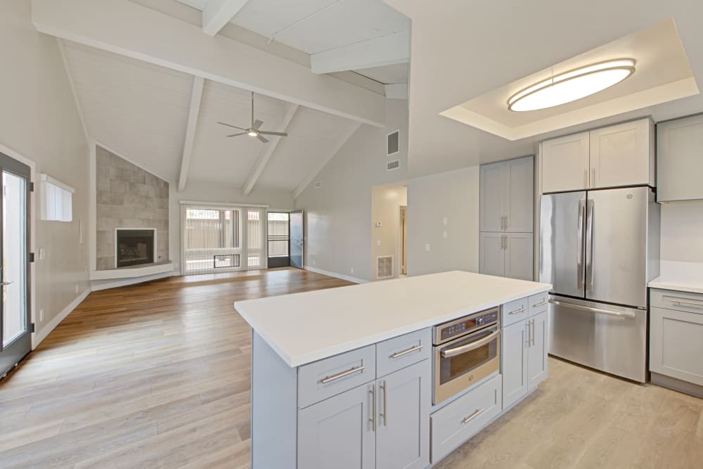 Bright modern kitchen with stainless steel appliances and an open living area at Sofi Ventura in Ventura, California