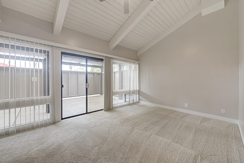 Spacious living area with sliding door access to a private patio at Sofi Ventura in Ventura, California