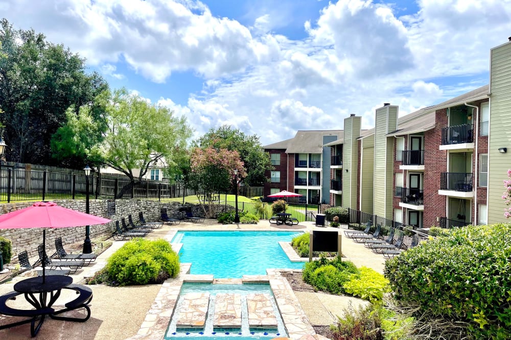 Enjoy a swimming and relaxing outdoor area at The Abbey at Medical Center in San Antonio, Texas