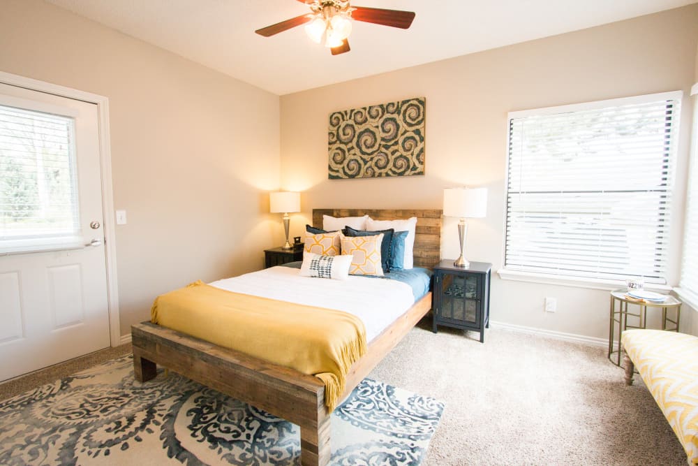 Large master bedroom with plush carpet at Ashford Belmar in Lakewood, Colorado