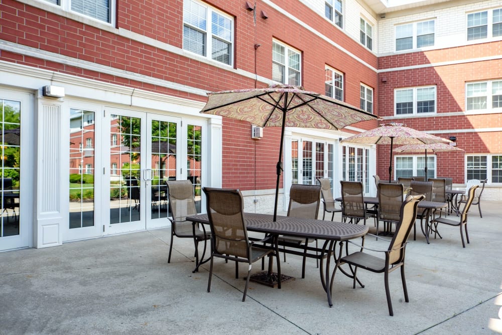 Outdoor shaded tables on the patio at Hanover Place in Tinley Park, Illinois
