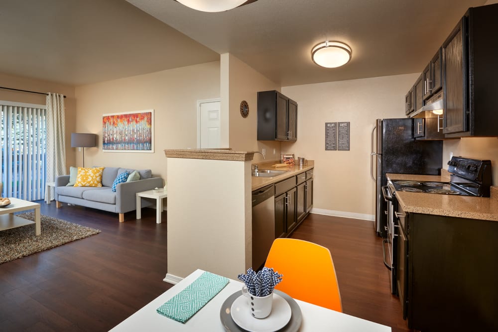 Kitchen with wood-style flooring at Crossroads at City Center Apartments in Aurora, Colorado