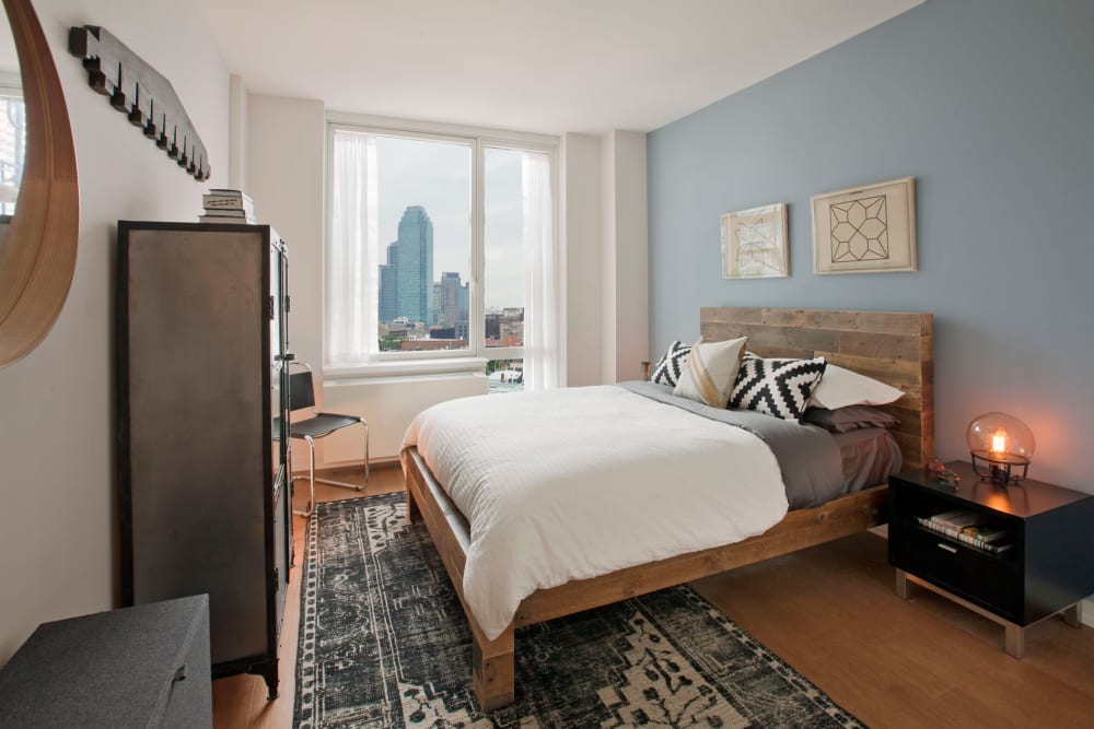 Bedroom with tons of natural light at The Maximilian in Queens, New York