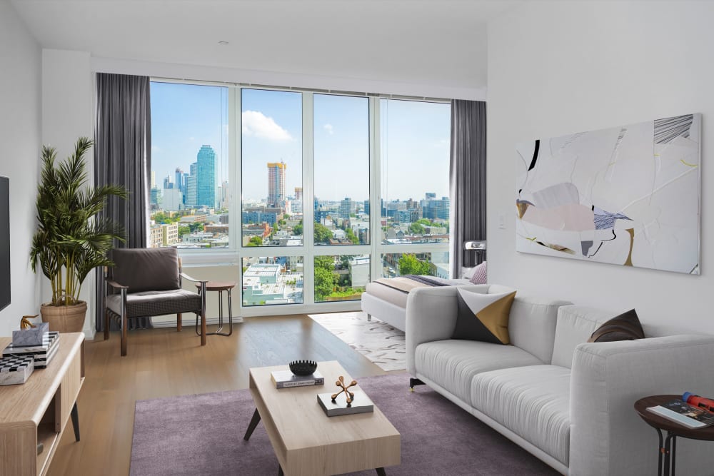 Great views of the city from the spacious living room at The Maximilian in Queens, New York