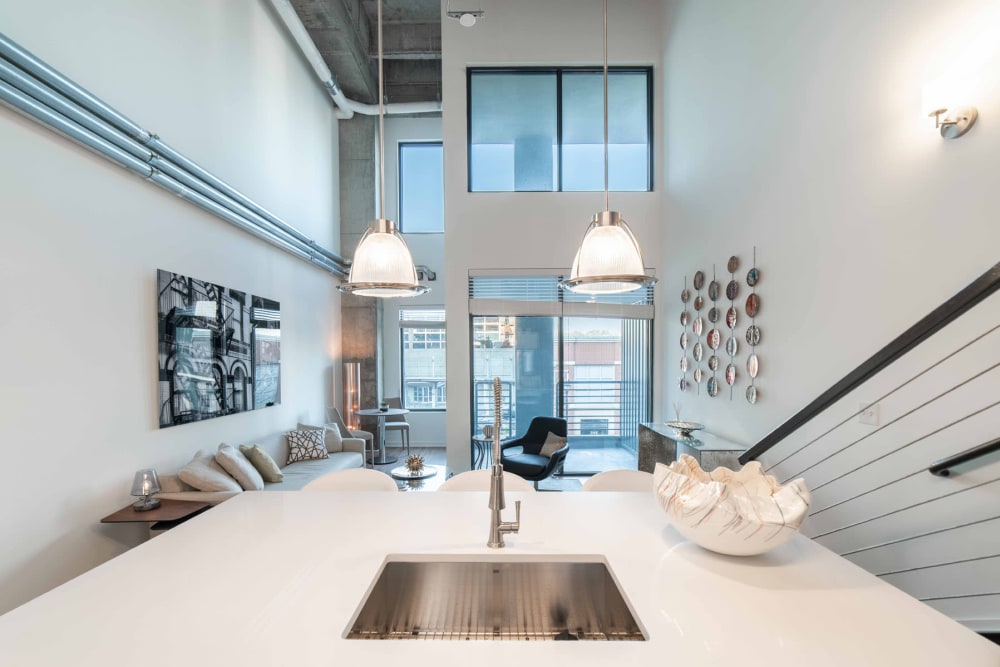 View of the living area from a model loft apartment's kitchen at 17th Street Lofts in Atlanta, Georgia