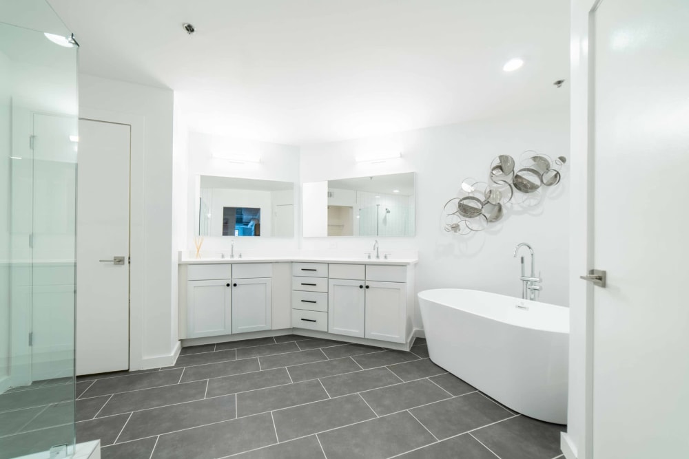 Roomy bathroom with hardwood flooring and a quartz countertop in a model loft at 17th Street Lofts in Atlanta, Georgia