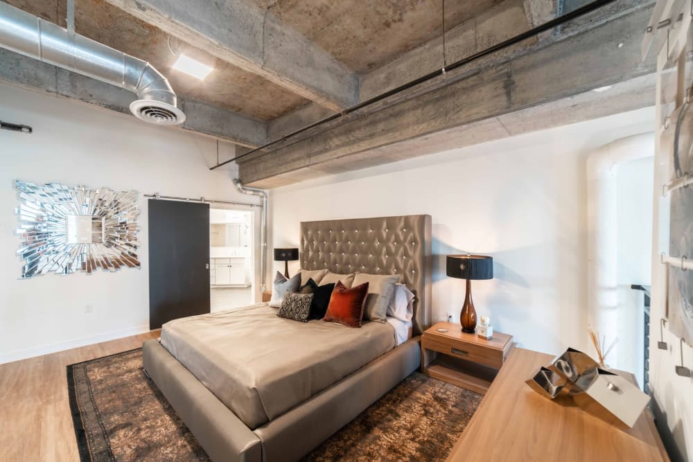 Well-furnished bedroom in a model loft at 17th Street Lofts in Atlanta, Georgia