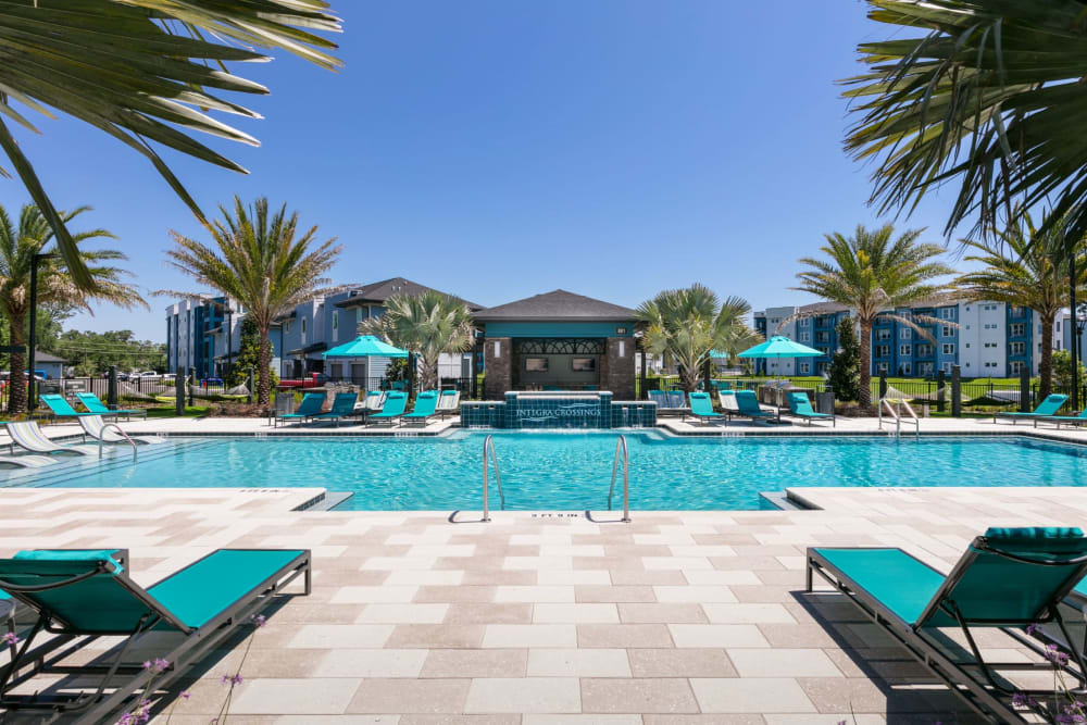 Pool with sun chairs at Integra Crossings in Sanford, Florida