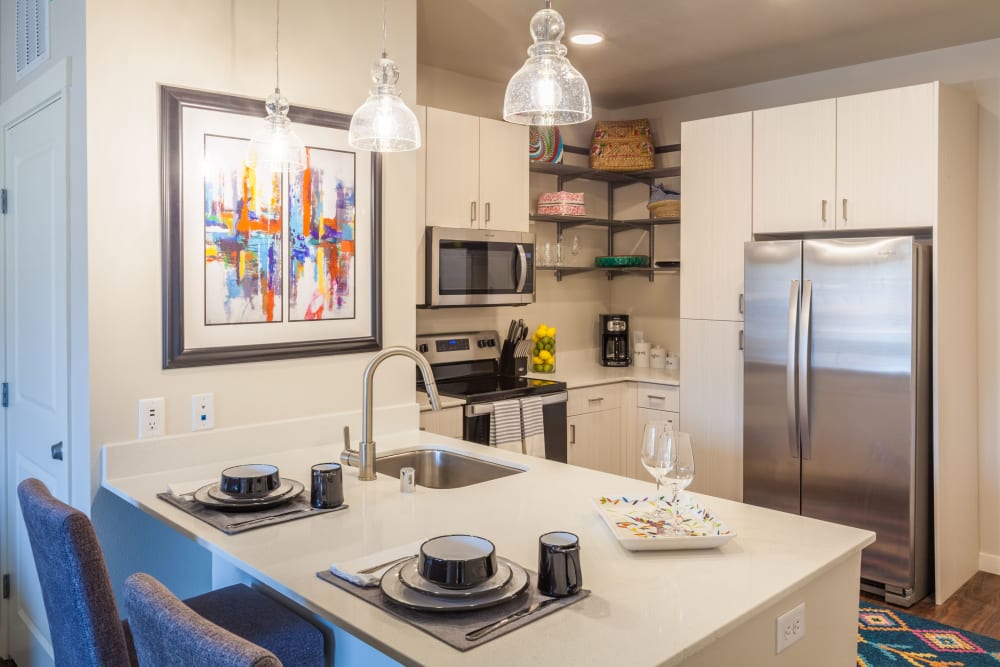 Model kitchen with stainless-steel appliances at Capitol Flats in Santa Fe, New Mexico