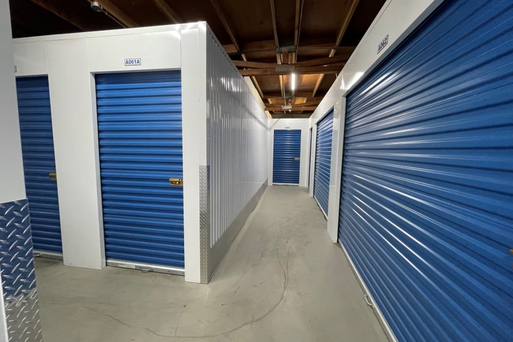 Indoor hallway access to storage units at Storage Solutions in Pomona, California