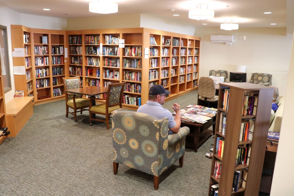 Residents sitting in library area at The Springs at Greer Gardens in Eugene, Oregon