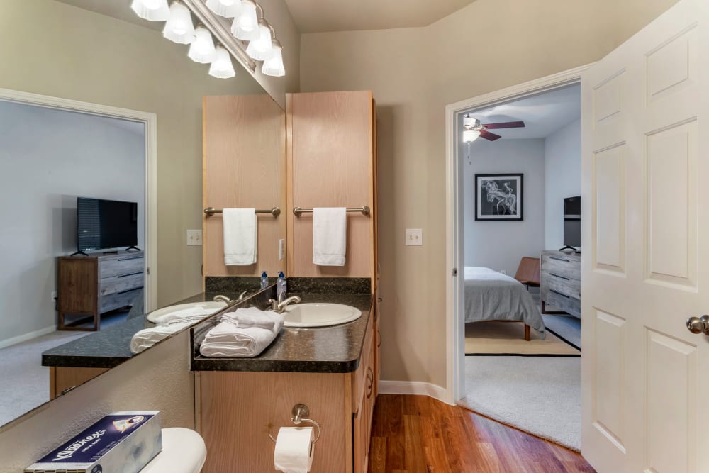 Model bathroom with oversize mirror and plenty of storage at Regency at First Colony in Sugar Land, Texas