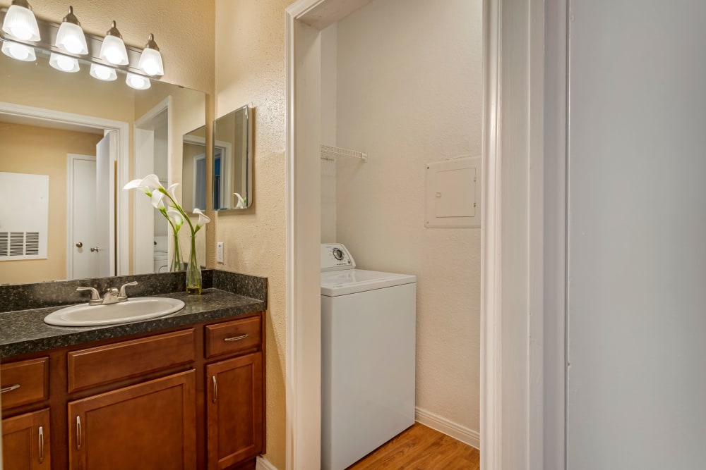 Laundry room with washer and dryer included next to a bathroom at Foundations at River Crest & Lions Head in Sugar Land, Texas