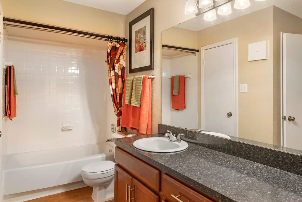 Model bathroom with oversized vanity and tub and tiled shower combination at Foundations at Austin Colony in Sugar Land, Texas