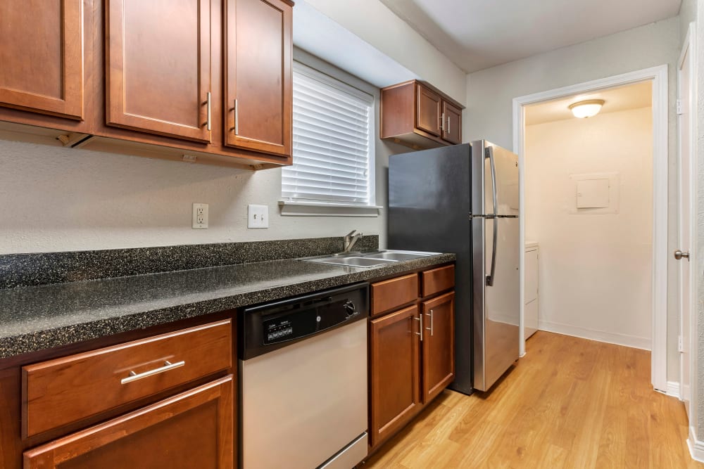 Fully equipped kitchen and a laundry room with washer and dryer connections at Foundations at Austin Colony in Sugar Land, Texas