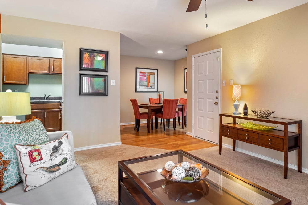 Well decorated model living room and dining area in an open layout apartment home at Foundations at Austin Colony in Sugar Land, Texas