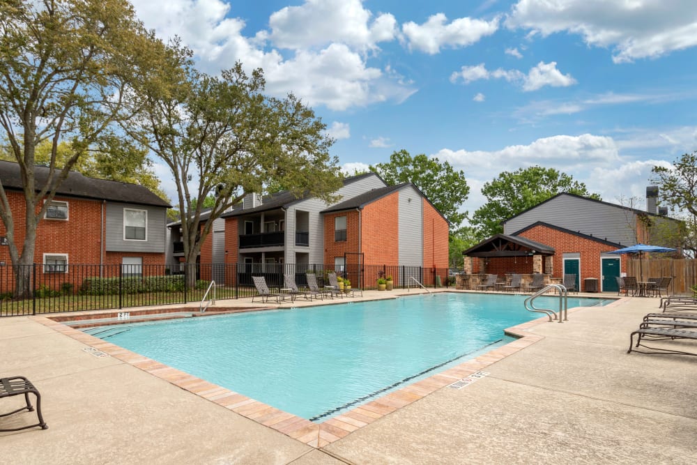 Sparkling swimming pool with an expansive sundeck at Foundations at Austin Colony in Sugar Land, Texas