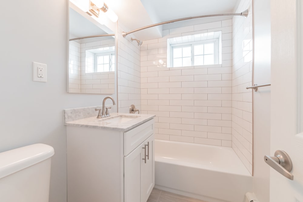 Bright, clean bathroom at Eagle Rock Apartments at Carle Place in Carle Place, New York