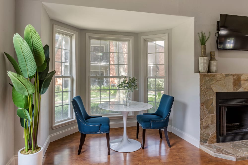 Table and chairs in front of a bay window in the resident clubhouse at Foundations at Austin Colony in Sugar Land, Texas
