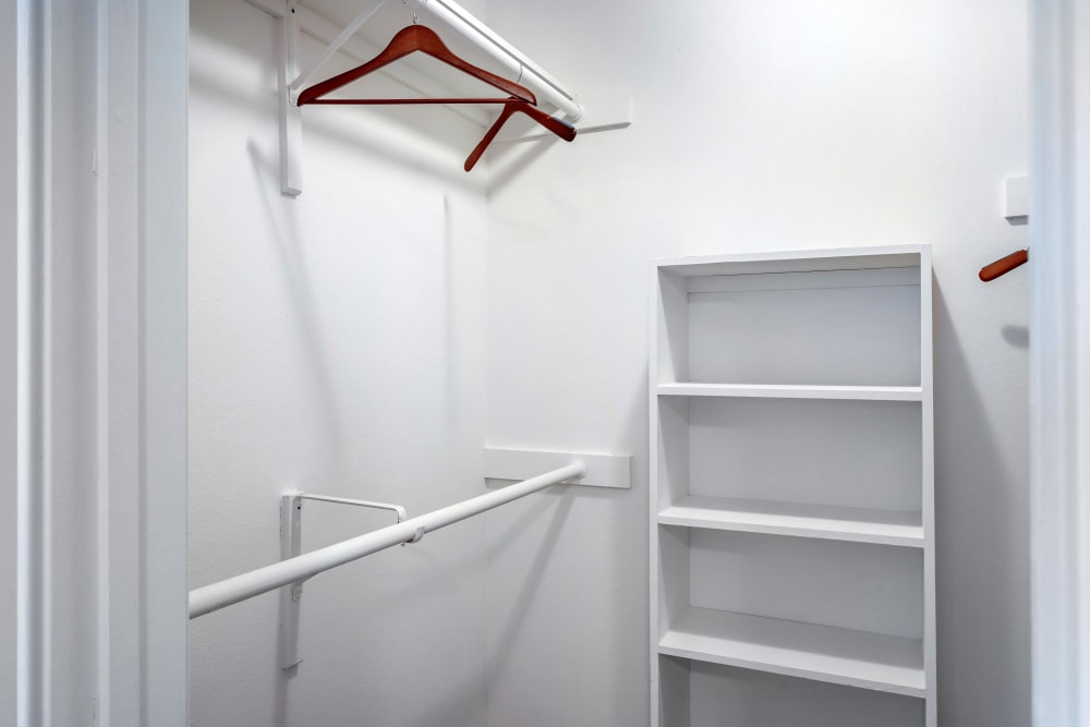 A spacious walk-in closet with built-in shelves at Foundations at Edgewater in Sugar Land, Texas