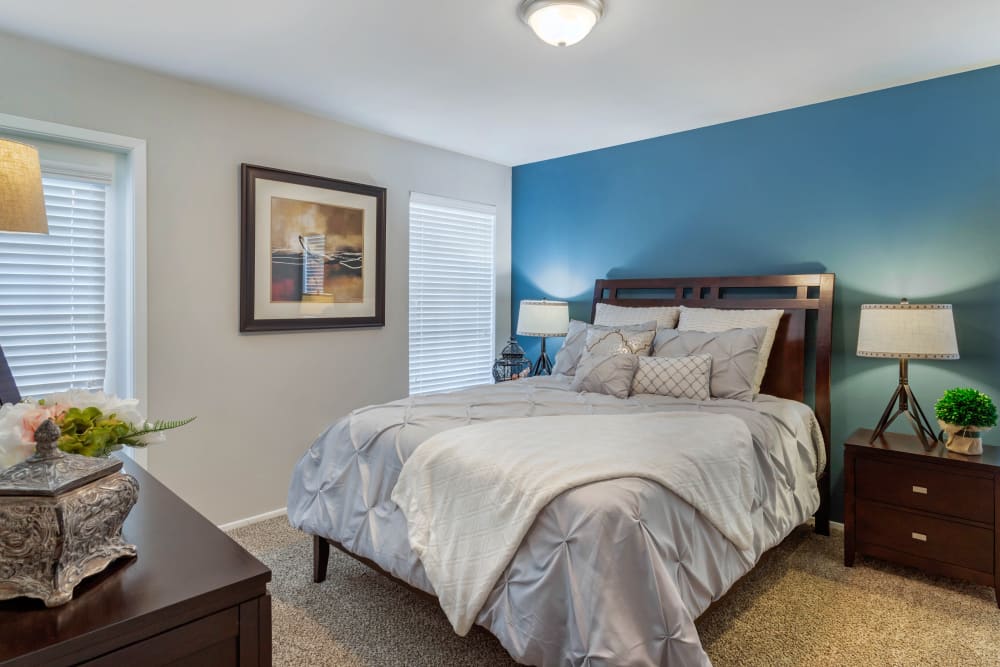 Well lit model bedroom with plush carpeting at Foundations at Edgewater in Sugar Land, Texas