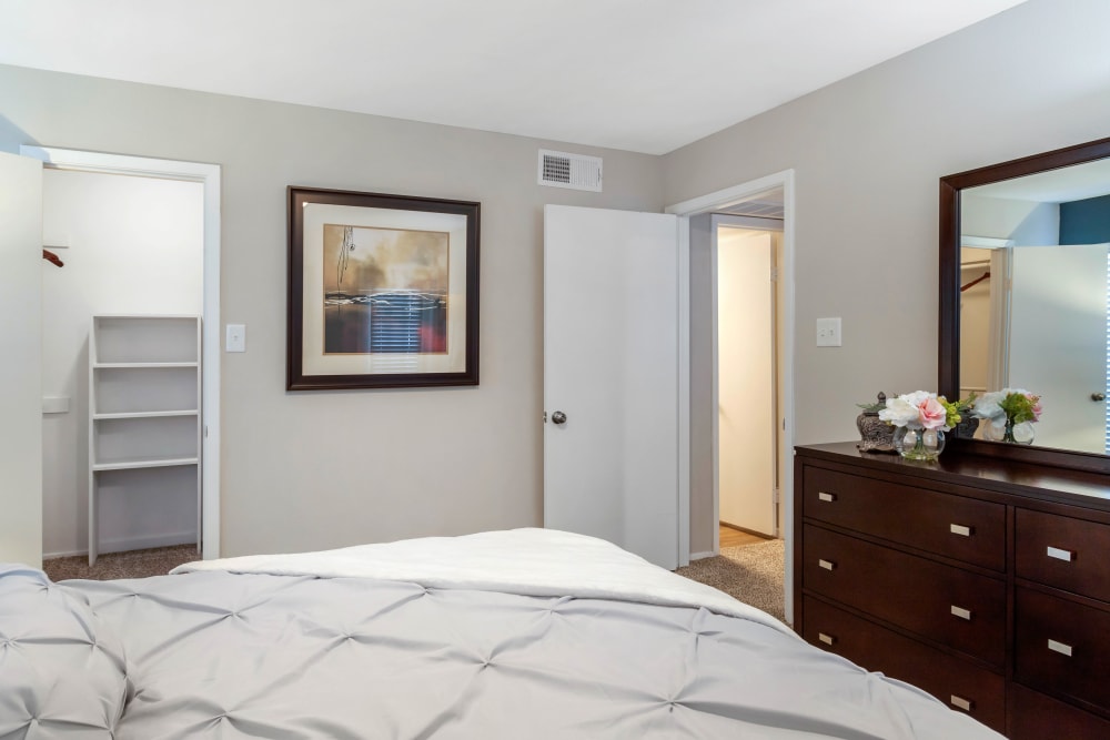 Model bedroom with a spacious walk-in closet at Foundations at Edgewater in Sugar Land, Texas