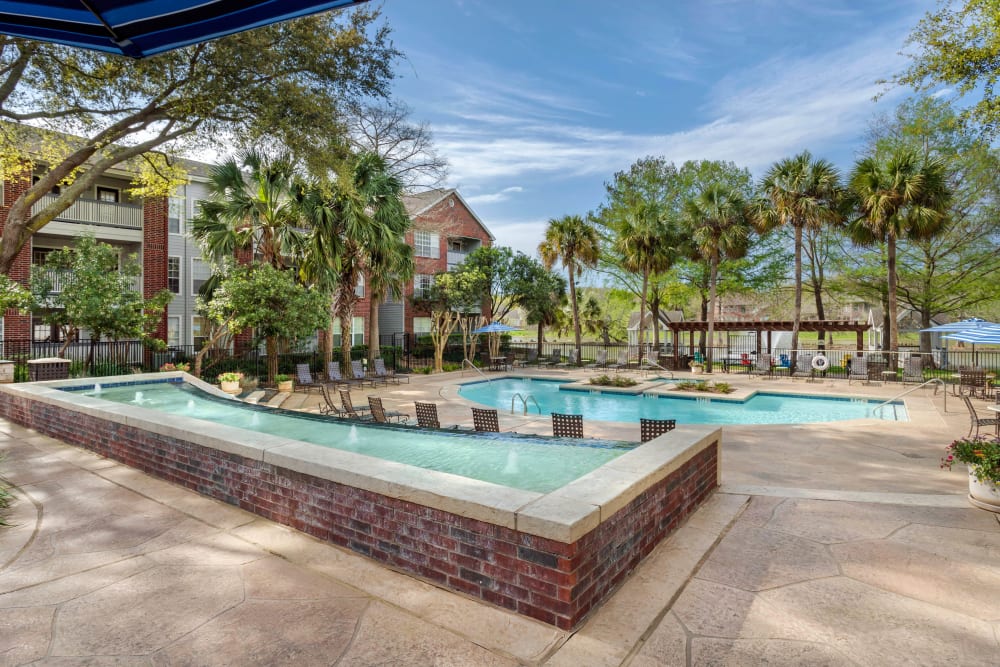 Lakeside resort-inspired swimming pool with expansive sundeck at Foundations at Edgewater in Sugar Land, Texas