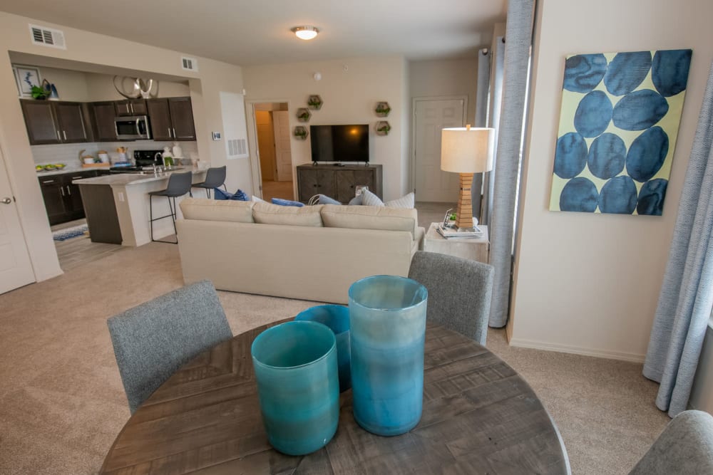 View of the spacious open-concept living area from the dining nook in a model apartment at Redbud Ranch Apartments in Broken Arrow, Oklahoma