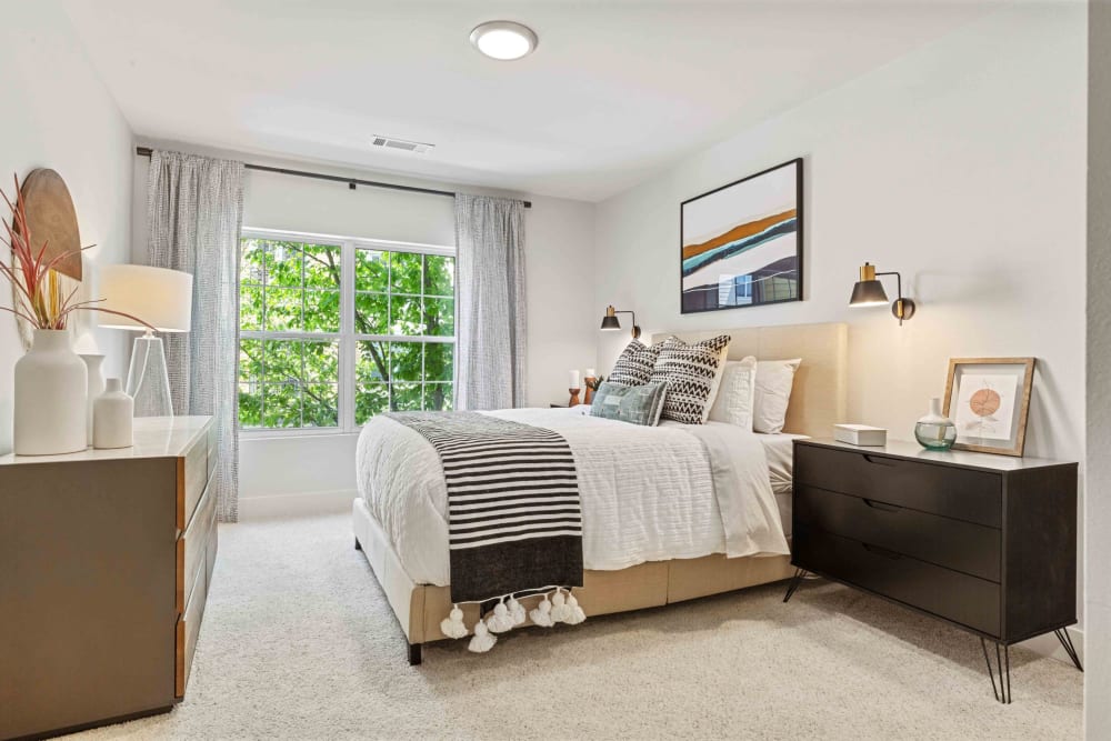 Bright bedroom with a large window at Sofi at Salem Station in Salem, Massachusetts