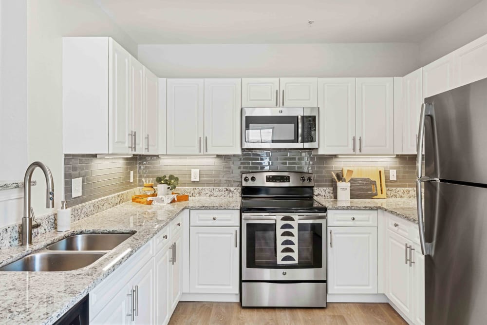 Bright kitchen with stainless steel appliances at Sofi at Salem Station in Salem, Massachusetts