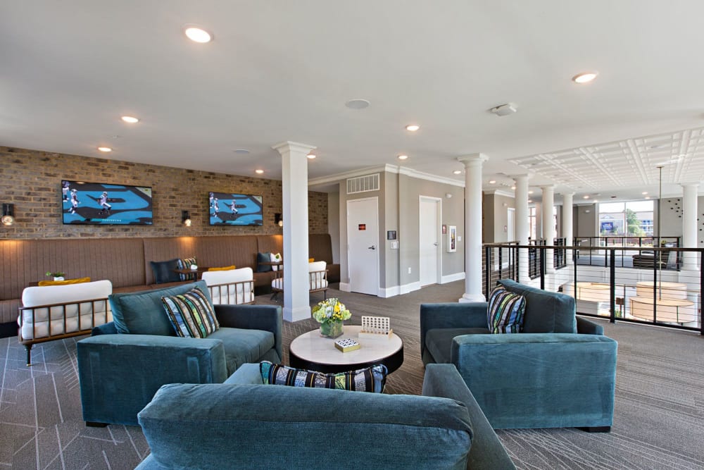 Upstairs lounge area with very cozy blue chairs to relax in at 8 Metro Station in Charlotte, North Carolina