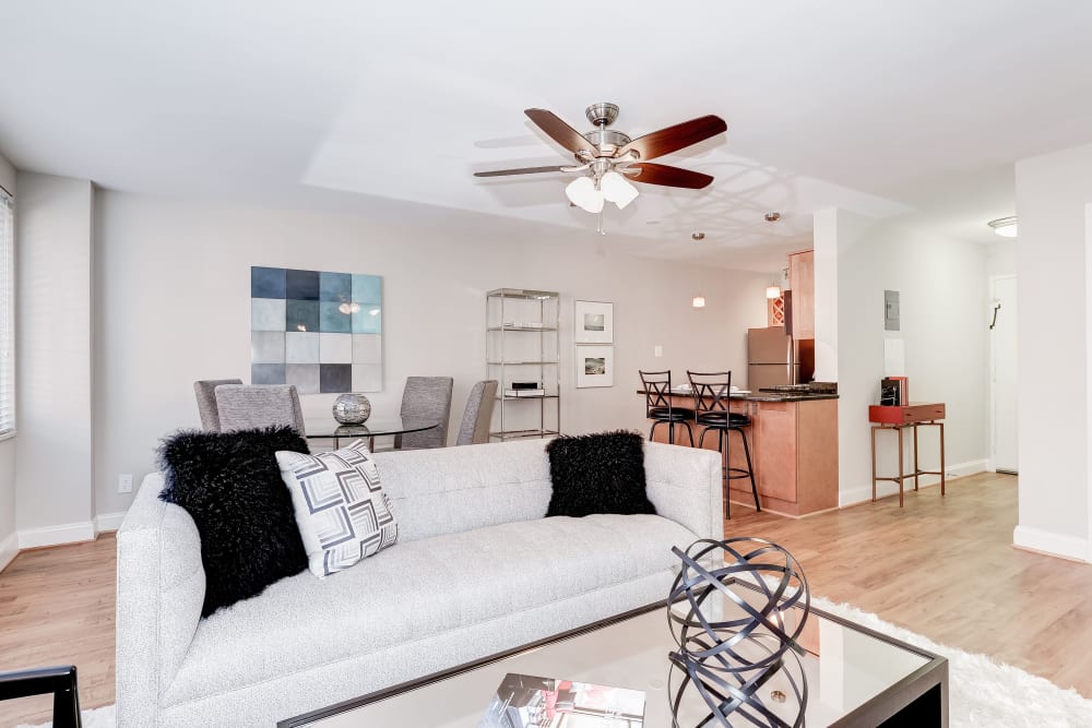 Living room with a ceiling fan to help stay cool and a large comfy couch at Bristol House in Washington, District of Columbia