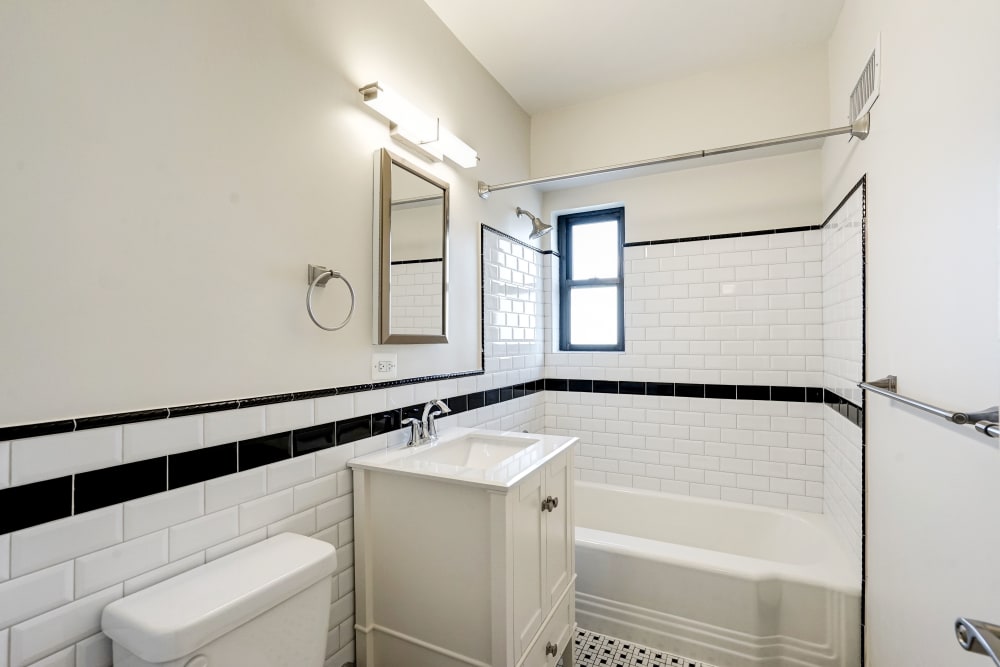 Bathroom with cool striped tile design around the wall at Dorchester House in Washington, District of Columbia
