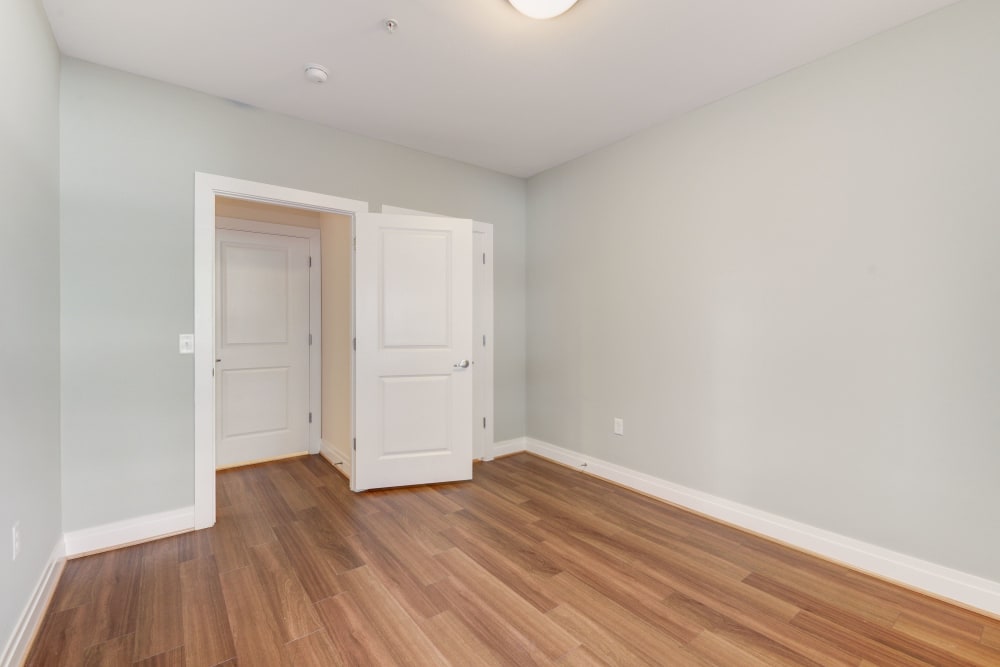 Wood style flooring in the bedrooms with lots of light at Dorchester West in Washington, District of Columbia