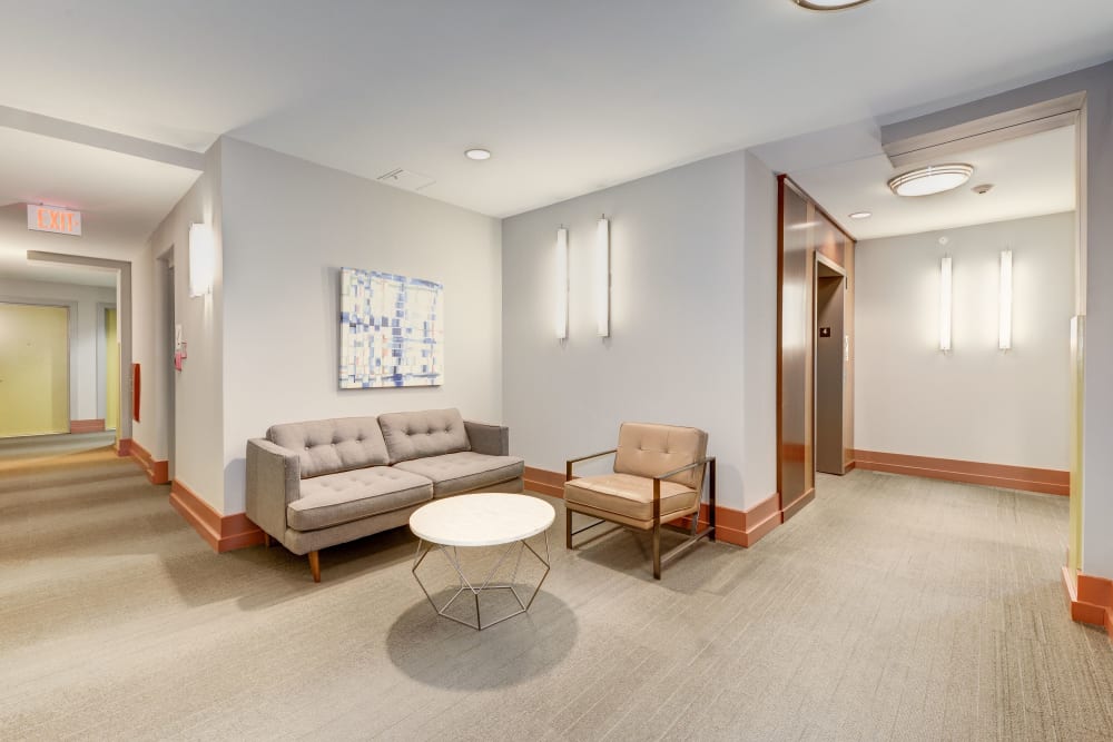 A cozy couch in the hallway next to the elevators at Dorchester West in Washington, District of Columbia