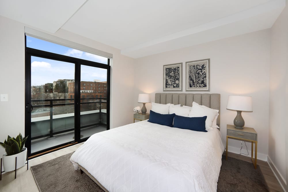 Well lit bedroom with incredible views of the city at Madrona Apartments in Washington, District of Columbia