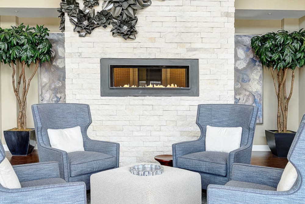 Fireplace surrounded by cozy chairs to relax in on a cold day at The Retreat at Market Square in Frederick, Maryland