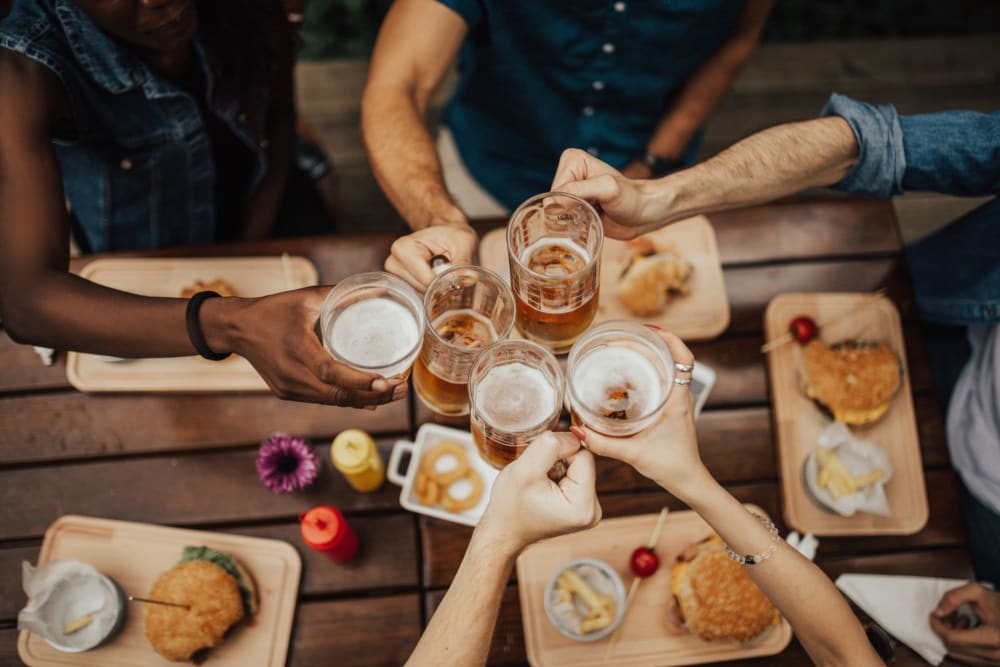 Big group of friends enjoying some tasty beers and bites to eat near Winston House in Washington, District of Columbia