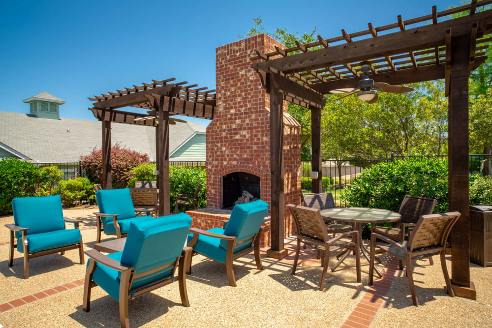 Lounge with brick fireplace and pergolas Sunstone Village in Denton, Texas.